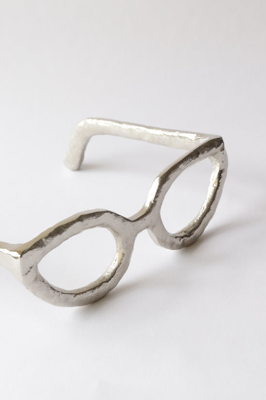 Acento de lentes plateado